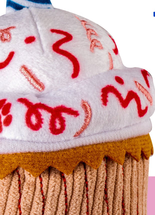 Toy resembling a cupcake with red paw prints on a white background