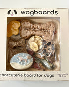 Wagboards charcuterie board for dogs with various treats in a clear window box.