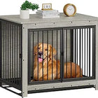 Dog inside a large metal crate with a wooden frame, sitting on a table.